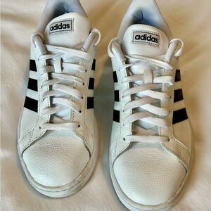 Adidas Classic White Sneakers with Black Stripes.